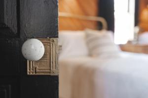 a close up of a door with a ball on it at The Gilded Lady - The Cypress Suite in Pensacola