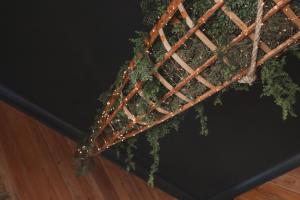 a fence with green plants in a room at The Gilded Lady - The Cypress Suite in Pensacola