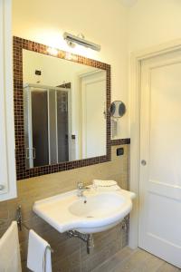 a bathroom with a white sink and a mirror at Residence Les Amis in Castel di Sangro +63 photos