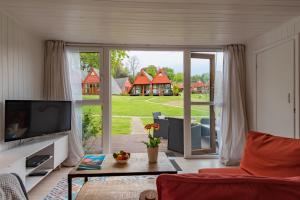 a living room with a large sliding glass door at Chalet 53 in Deal