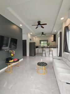a living room with a couch and a table at jessi house pool in Ban Nok