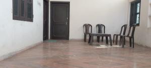 three chairs and a table in front of a door at Ladies homestay in Jhunjhunūn