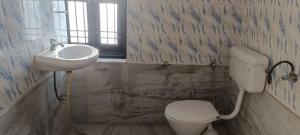 a bathroom with a toilet and a sink at Ladies homestay in Jhunjhunūn