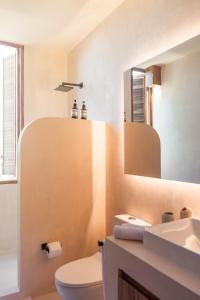 a bathroom with a sink and a toilet and a mirror at Condominios Punta Morelos in Brisas de Zicatela +44 photos