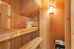 a wooden sauna with a clock on the wall at Sekobbe 218 - Baabe in Baabe