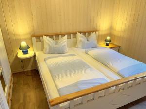 a bedroom with two beds and two lamps on tables at Sekobbe 218 - Baabe in Baabe +12 photos
