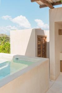a villa with a swimming pool and a house at Condominios Punta Morelos in Brisas de Zicatela