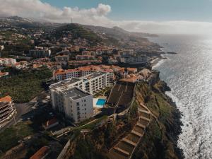 an aerial view of a city and the ocean at Atlantic Residence Pool & Ocean View in Câmara de Lobos