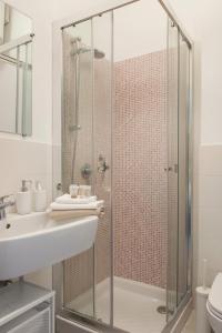 a bathroom with a glass shower and a sink at San Siro - 1st Studio & free wifi in Milan +3 photos