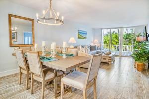 a dining room with a table and chairs and a couch at Lighthouse Point 222 in Sanibel