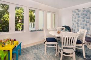 a dining room with a table and chairs and windows at Lighthouse Point 222 in Sanibel +11 photos