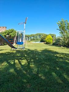 a playground with a slide in a grass field at Casa Quinta Nuevo Torino -15 min de Rafaela in Nuevo Torino