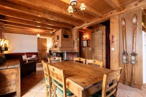 a dining room with a wooden table and chairs at Chalet Savoyard in La Clusaz