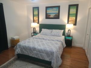 a bedroom with a bed and two lamps on two tables at The Taunton House in Ajax +18 photos