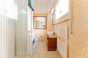 a bathroom with a toilet and a sink at Sempione Color Milano CityLife Fiera District in Milan +73 photos