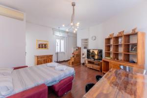 a bedroom with a bed and a tv and a table at Sempione Color Milano CityLife Fiera District in Milan