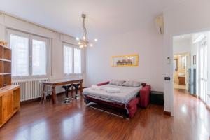 a living room with a red couch and a desk at Sempione Color Milano CityLife Fiera District in Milan