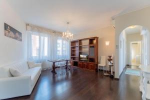 a living room with a white couch and a table at Sempione Color Milano CityLife Fiera District in Milan