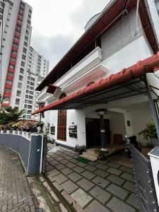 a white building with a red roof at Metro Bliz Alua by thestaypoint in Alwaye