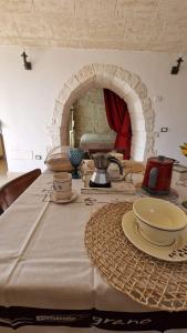 a table with a white table cloth on it at Trulli Beauty LAMIA family pool in Martina Franca