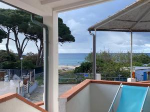 a view of the ocean from the balcony of a house at Appartamenti Seccheto in Seccheto