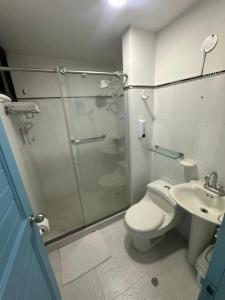 a bathroom with a shower and a toilet and a sink at TAMA Hotel Santa Marta in Santa Marta
