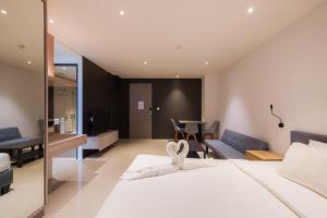 a bedroom with a bed with a towel on it at Propify Central Serviced Residence in Ban Ket Ho +31 photos