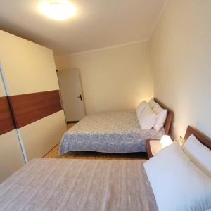 a small room with two beds in it at Il Roseto Mountain Lake Iseo Hospitality in Bossico