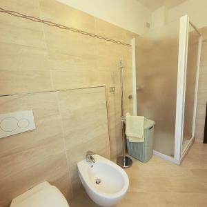 a bathroom with a toilet and a sink and a shower at Il Roseto Mountain Lake Iseo Hospitality in Bossico +14 photos