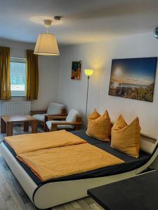 a bedroom with a bed and a living room at HerbergeZumBrieselang in Brieselang