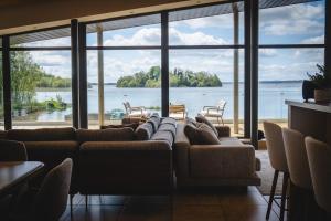 a living room with a couch and a large window at Sheelin Lake House in Cavan