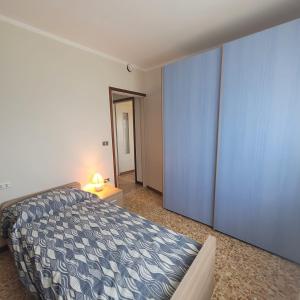 a bedroom with a bed and a large blue closet at Il Roseto Mountain Lake Iseo Hospitality in Bossico