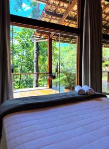 a bedroom with a bed and a large window at Pousada Santa Vila in Serra do Cipo +126 photos