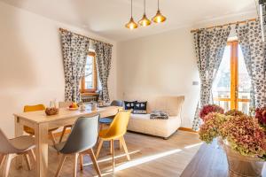 a living room with a table and chairs and a couch at Residence La Baita in Frassinetto