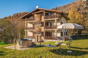 a house with a table and chairs in front of it at Residence La Baita in Frassinetto