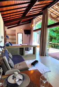 a living room with a couch and a table at Pousada Santa Vila in Serra do Cipo