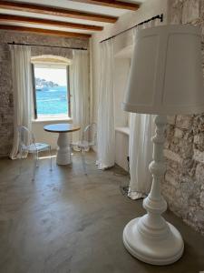 a white lamp in a room with a table and a window at Riva Lavanda Hvar, Old Town in Hvar +59 photos