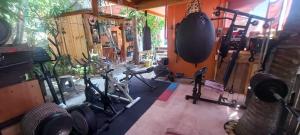 a gym with treadmills and weights in a room at Casa Gio Paraiso Escondido in Puerto Escondido