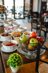a table with bowls of apples and other food at Premium Tower Suites Mendoza in Mendoza
