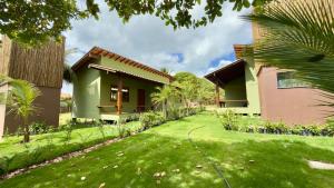 a house with a lawn in front of it at Villa 4 Elements, Studios Praia de Saquaíra, Maraú in Marau +8 photos