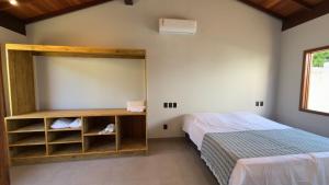 a bedroom with a bed and a large mirror at Villa 4 Elements, Studios Praia de Saquaíra, Maraú in Marau