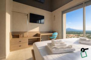 a bedroom with a bed with a desk and a window at Hotiday Lerici Trebiano in Lerici