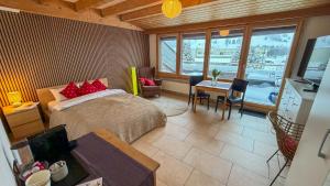 a bedroom with a bed and a table with a dining room at PlanB Stay in Samedan +7 photos