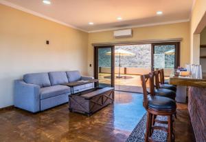 a living room with a blue couch and a table at Pent house in Cabo Pulmo +3 photos