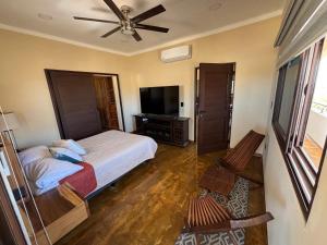 a bedroom with a bed and a flat screen tv at Pent house in Cabo Pulmo