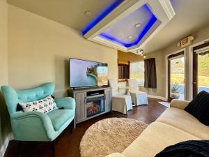 a living room with a couch and a tv at Haven at Hazel - the Residence in Demorest