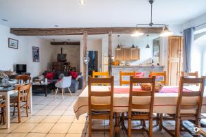 a dining room and living room with a table and chairs at Château Besson in Montluçon