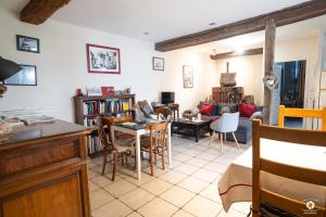 a living room with a couch and a table and chairs at Château Besson in Montluçon