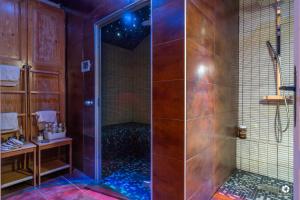 a shower with a glass door in a bathroom at Château Besson in Montluçon +44 photos