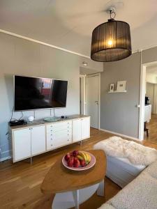 a living room with a bowl of fruit on a table at Lägenhet centralt i Mora in Mora